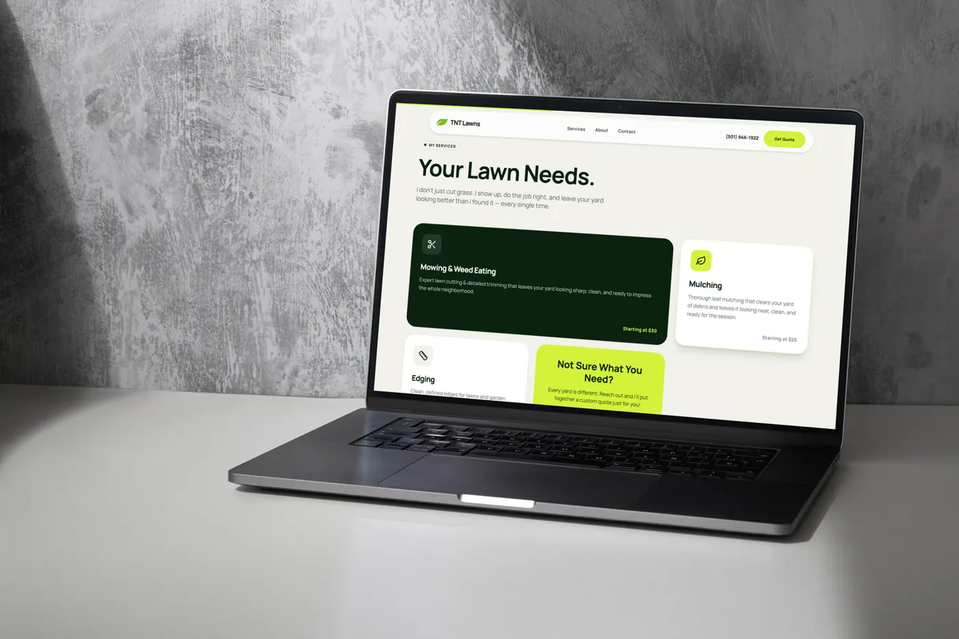 TNT Lawn Care website on a laptop